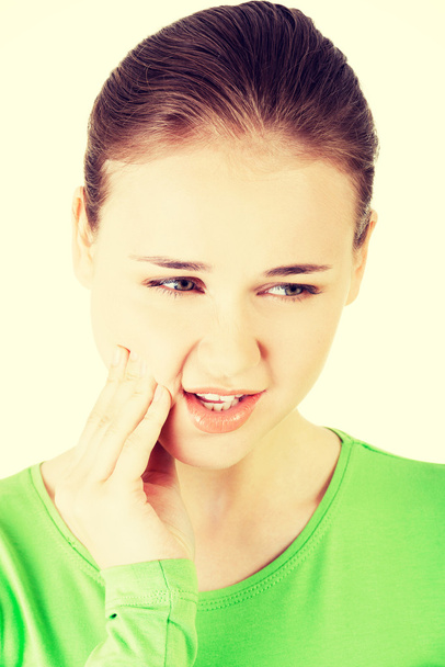 Teen woman having a terrible tooth ache. - 写真・画像