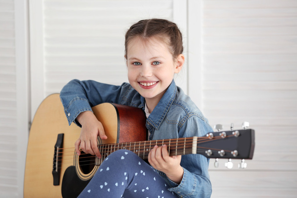Little girl playing guitar  - Photo, image
