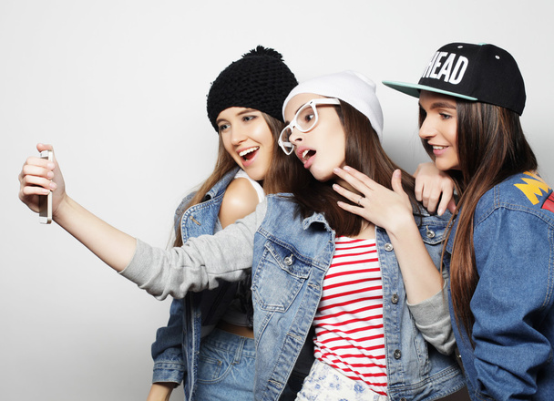 three happy teenage girls with smartphone taking selfie - Valokuva, kuva