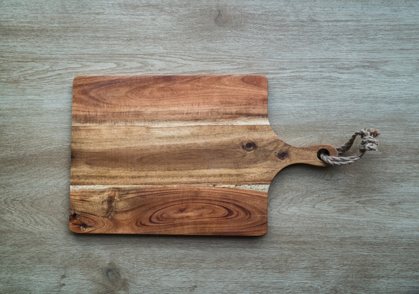 Cutting board on wooden background - Photo, Image