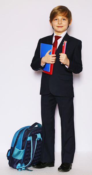 schoolboy in suit and tie with a notebook, ready to go to school - Фото, изображение