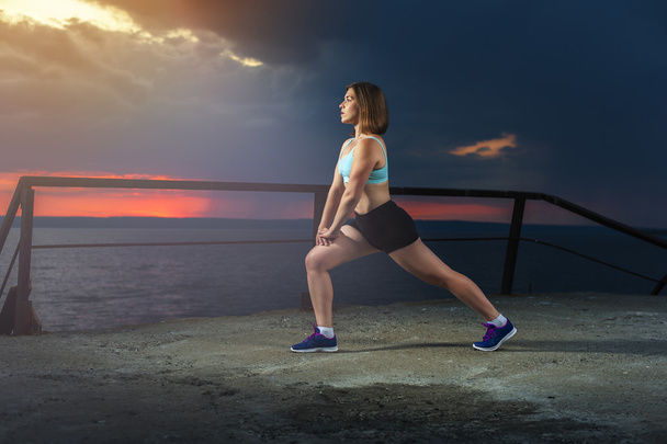 Fit woman stretching legs before workout - Φωτογραφία, εικόνα