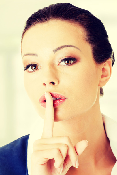 Portrait of attractive business woman with finger on lips - Foto, immagini