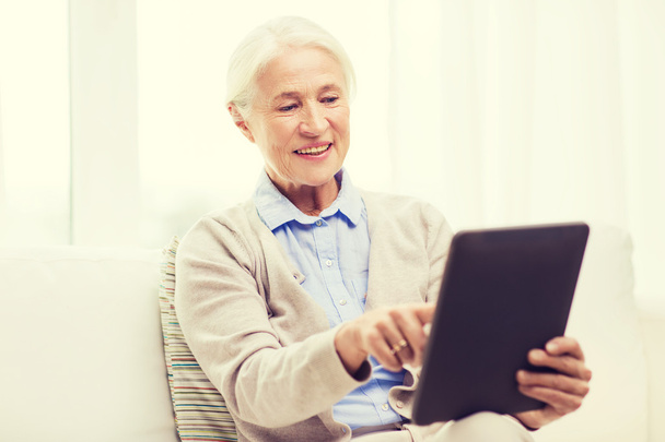 happy senior woman with tablet pc at home - Фото, зображення