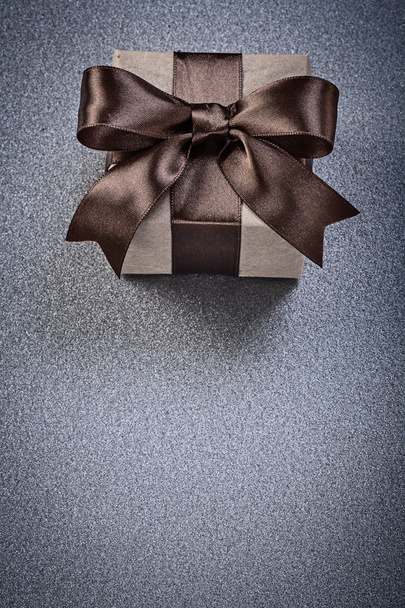 Wrapped present box on grey background celebrations concept - Photo, image