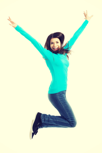 Young casual woman, student jumping. - Φωτογραφία, εικόνα