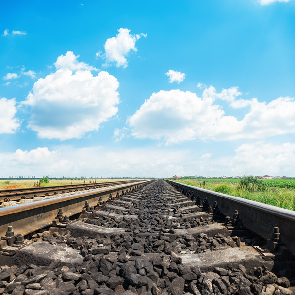 railroad closeup to horizon and bright day with blue sky and whi - Fotó, kép
