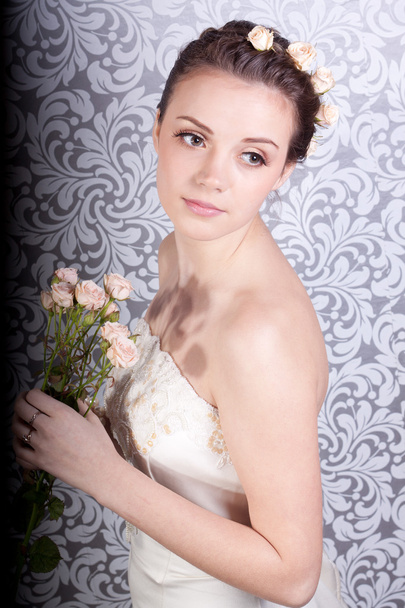 Cute girl in a wedding dress with a bouquet - Photo, Image