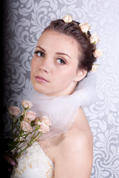 Cute girl in a wedding dress with a bouquet - Foto, imagen