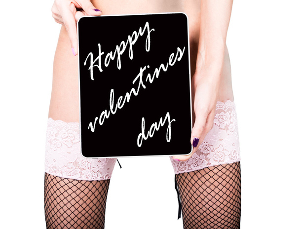 technology, internet and networking - close-up ass of girl in lacy lingerie, holding a tablet pc happy valentines day sign. Adult content, young woman holding aq gift - Фото, изображение