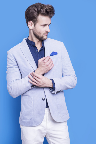 Handsome man in a dark blue shirt and blue jacket  - Φωτογραφία, εικόνα