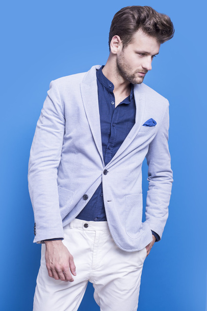Komea mies tummansininen paita ja sininen takki
  - Valokuva, kuva