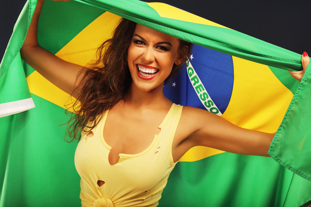 Happy Brazilian fan cheering with flag  - Photo, Image
