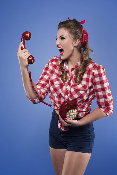 Wütendes Pin-up-Mädchen schreit in Telefon - Foto, Bild