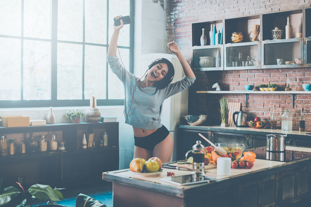 Woman dancing in kitchen  - Zdjęcie, obraz