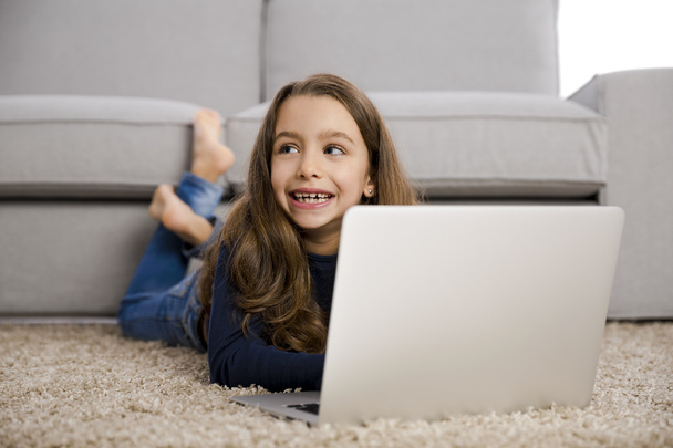 Little girl working with a laptop - Photo, Image