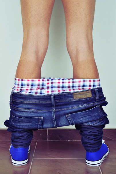 young man with his pants down seen from behind - Photo, Image