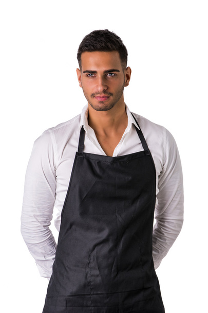 Young chef or waiter wearing black apron isolated - Фото, изображение