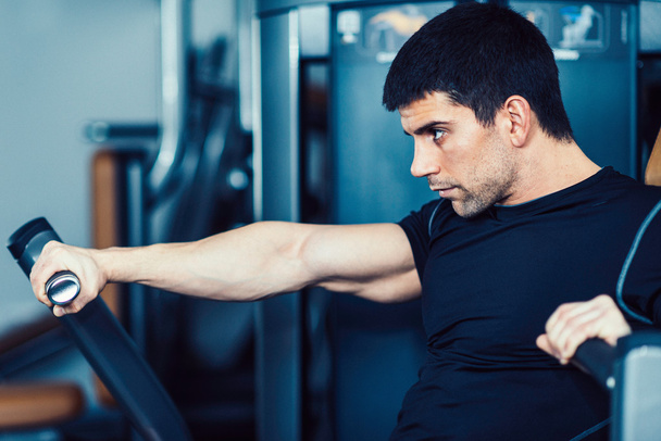 male athlete exercising in modern gym - Photo, Image