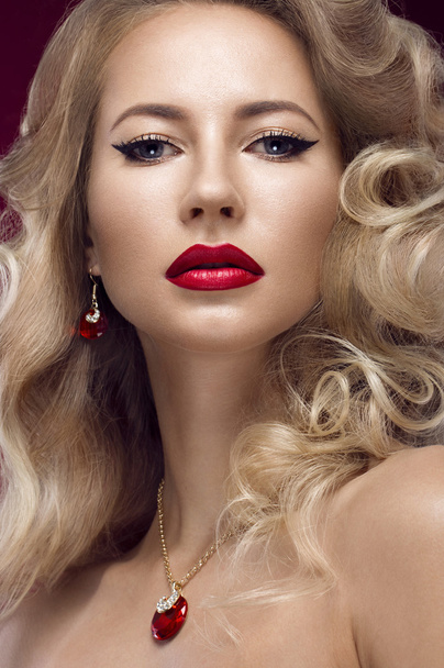 Beautiful blonde in a Hollywood manner with curls, red lips. Beauty face. - 写真・画像