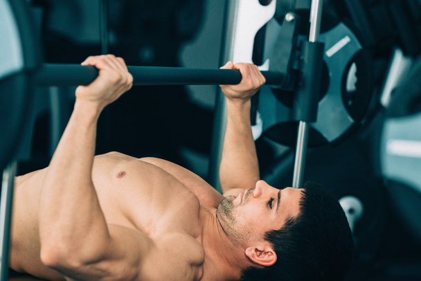 Man exercising on the bench press - Photo, Image