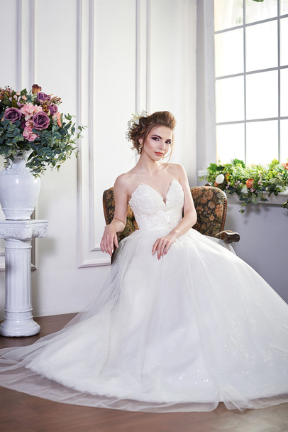 A photo of sexual beautiful bride in a wedding-dress is in fashion style. Wedding decorations - Zdjęcie, obraz