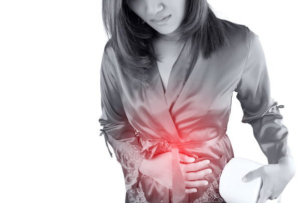 Vrouw met pijnlijke buikpijn op witte achtergrond - Foto, afbeelding
