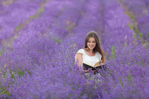 girl reading book in a lavender field - Photo, image