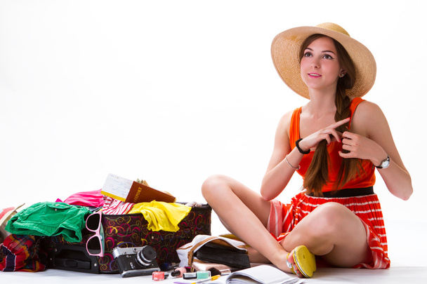 Sitting girl near overfilled suitcase. - Photo, Image