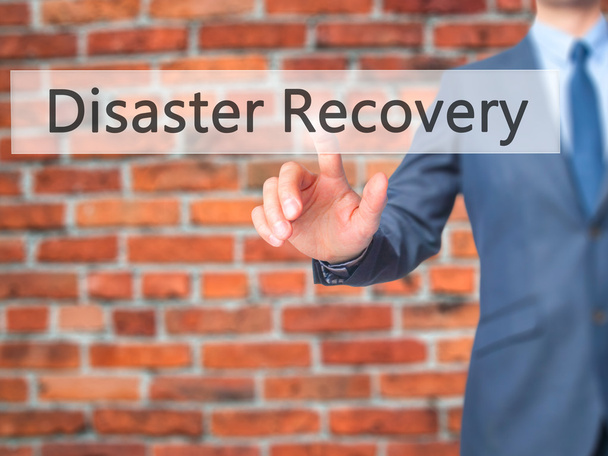 Disaster Recovery - Businessman hand pushing button on touch scr - Photo, Image