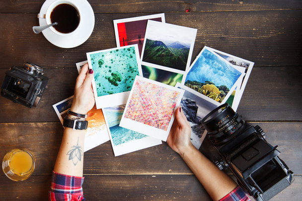 Woman's hands holding printed photos - Photo, Image