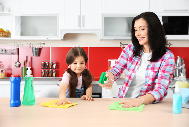 Daughter and mother cleaning kitchen table - Foto, Imagem