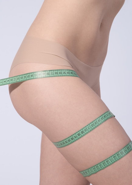 Woman measuring perfect shape of beautiful hips. Healthy lifesty - Zdjęcie, obraz