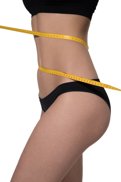 Slim woman body in black underwear measurement on white backgrou - Fotoğraf, Görsel