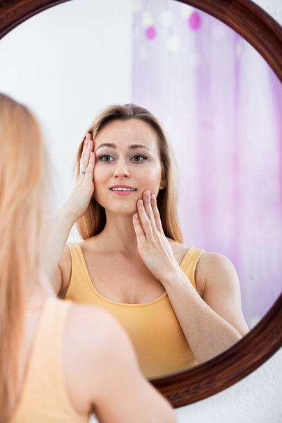 Woman having look at  mirror  - Фото, изображение