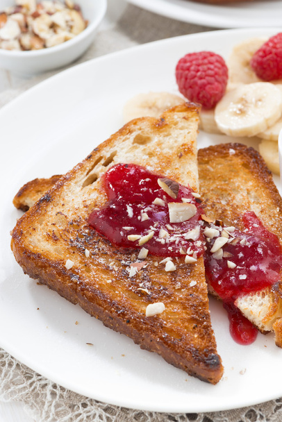 sweet breakfast - toasts with raspberries, banana and jam - Photo, image