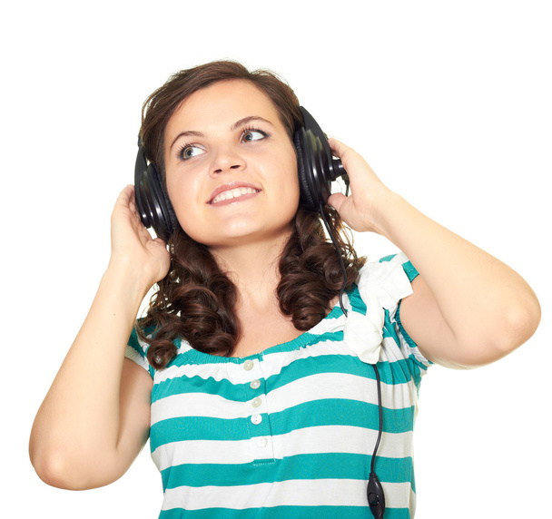 Jolie fille écoutant de la musique avec des écouteurs et levant les yeux
 - Photo, image