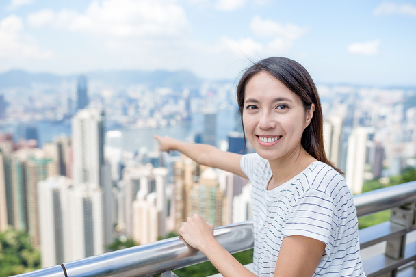 Woman traveler pointing to city of Hong Kong - Photo, Image