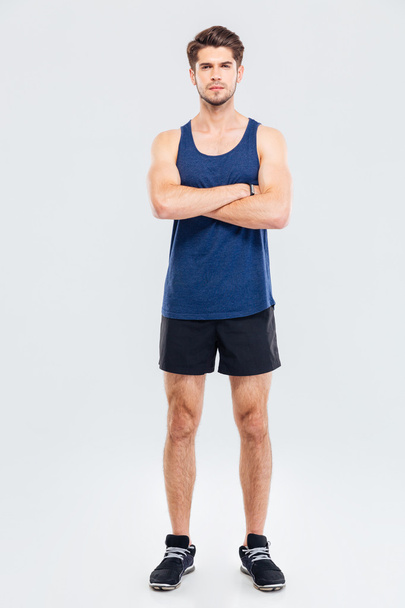 Full length portrait of a sportsman standing with hands crossed - Photo, Image