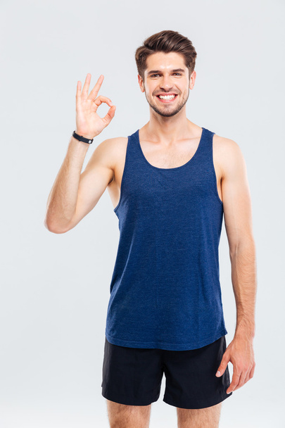 Close-up portrait of a fitness man showing okay sign - Photo, Image