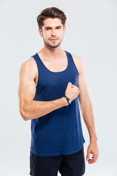 Close-up portrait of a concentrated man showing his biceps - Fotó, kép