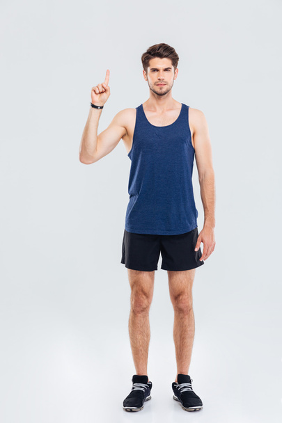 Full length portrait of a sportsman showing up on something - 写真・画像