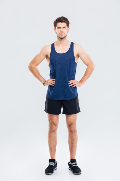 Full length portrait of sportsman standing with hands on hips - Photo, Image