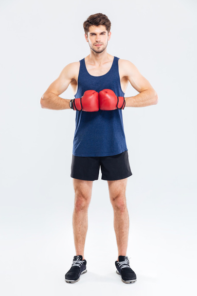 Full length portrait of a sportsman with red boxing gloves - Фото, зображення