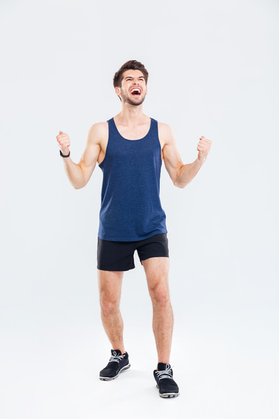 Full length portrait of a cheerful fitness man - Foto, afbeelding