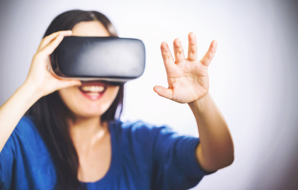 Woman using a virtual reality headset - Photo, Image