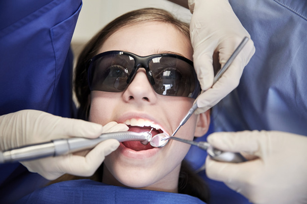 female dentists treating patient girl teeth - Фото, зображення