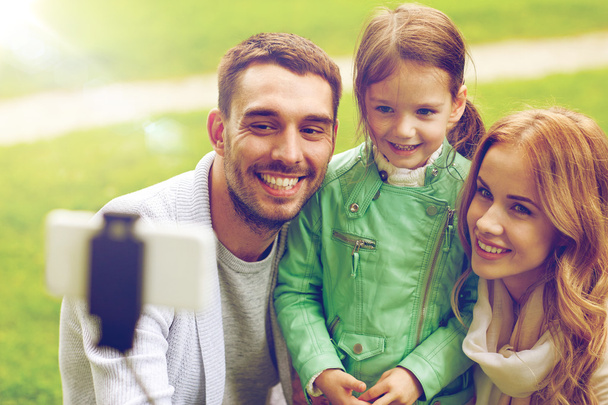 happy family taking selfie by smartphone outdoors - Фото, изображение