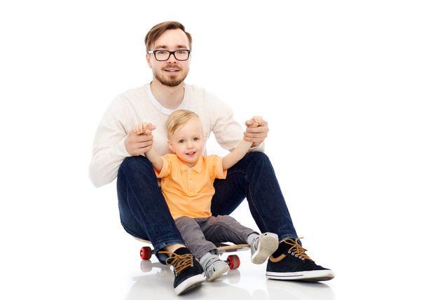happy father and little son on skateboard - Photo, image