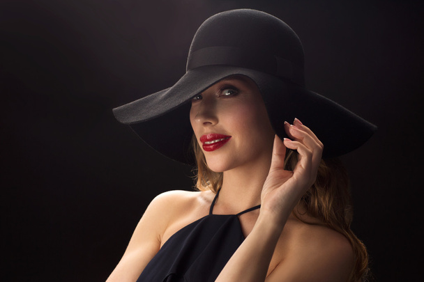 beautiful woman in black hat over dark background - Zdjęcie, obraz
